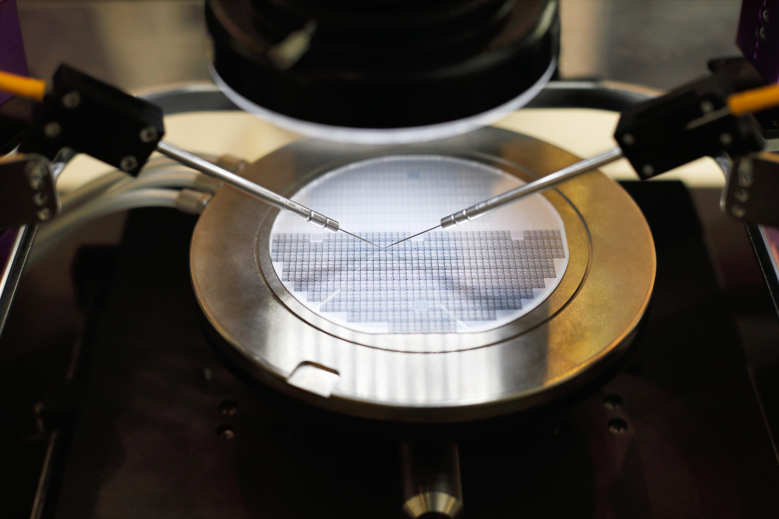Semiconductor silicon wafer undergoing probe testing. Selective focus.
