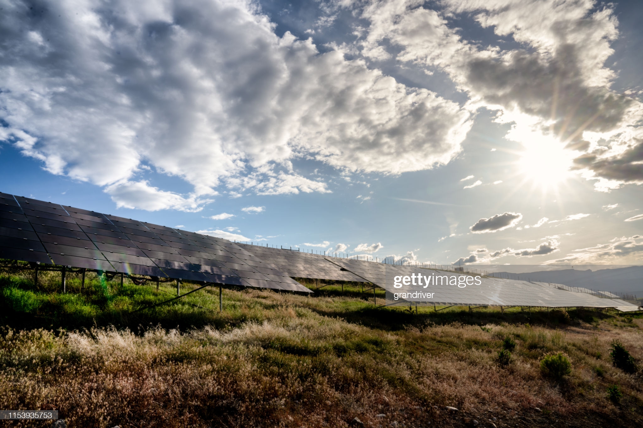 A beautiful blue sky and cloudscape around sunset at a solar farm in Western Colorado Pumps