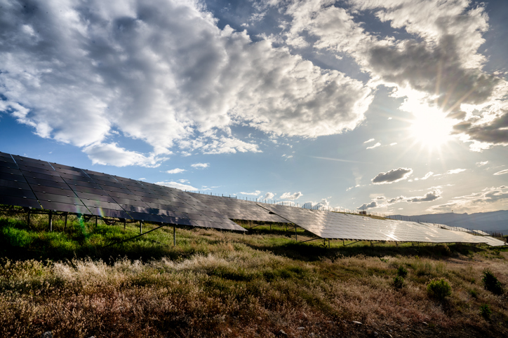 A beautiful blue sky and cloudscape around sunset at a solar farm in Western Colorado Pumps