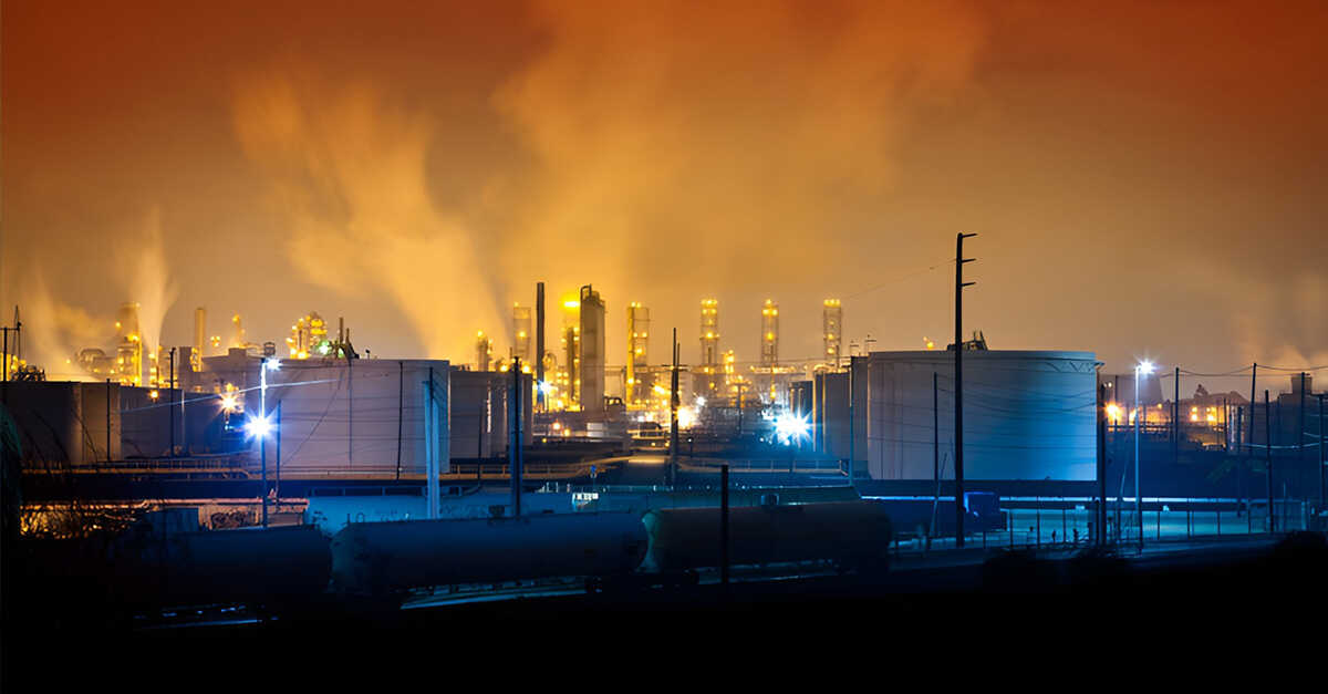 compression-seal-fitting-social oil refinery facility at night with storage tanks